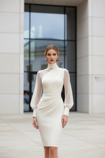 White dress with sheer sleeves worn by a model against a blurred architectural background