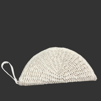 Close-up of the woven straw material of the Half Moon Raffia Clutch highlighting its craftsmanship and texture. 