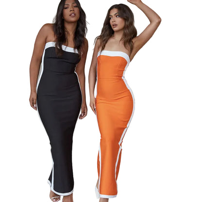 Two women wearing black and orange strapless dresses with white accents 
