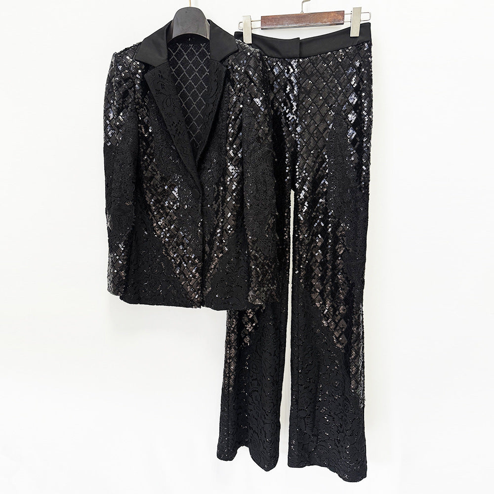 Front view of a hanging black lace blazer and wide-leg pants with sparkling sequins and a smooth waistband.