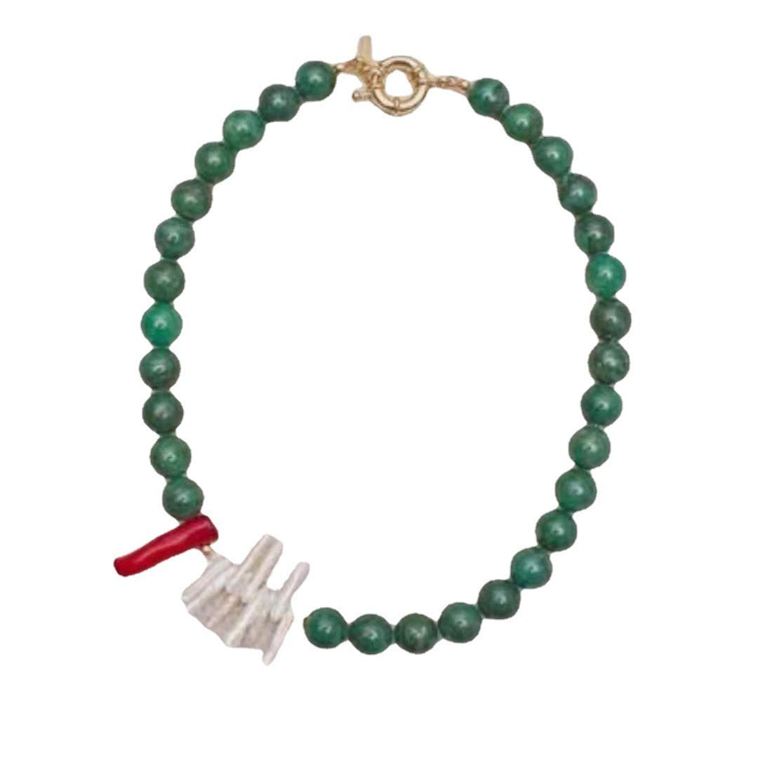Green beaded necklace with a unique charm 