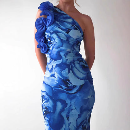 
Close-up of floral print pattern on blue sleeveless evening dress