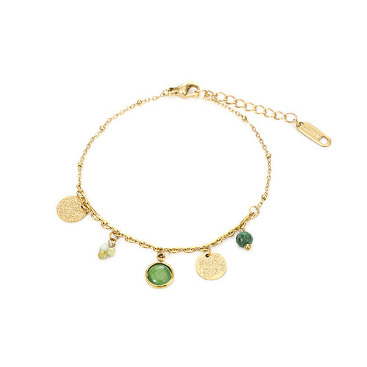 Gold bracelet with green gemstones