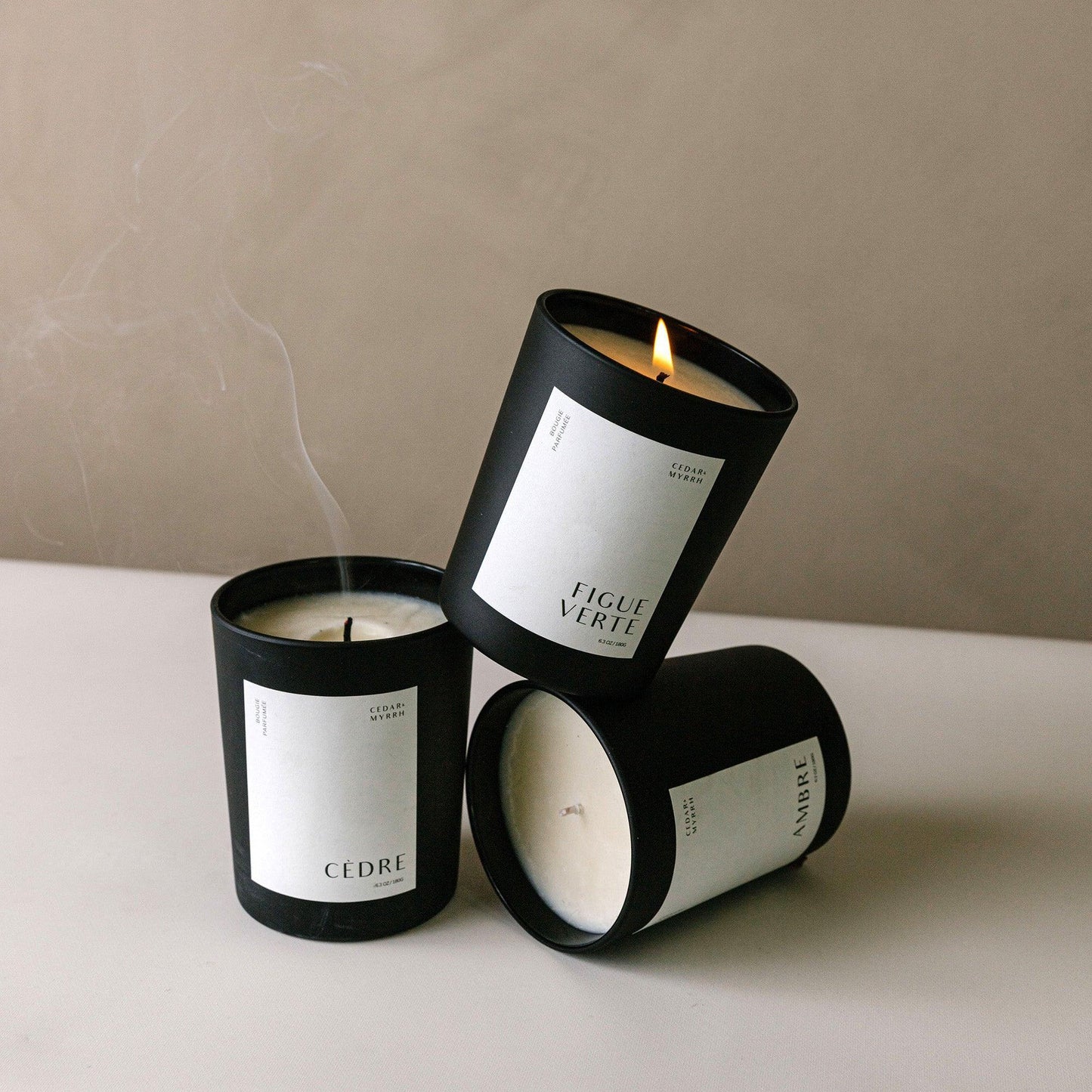 Three Figue Verte candles with black lids and white labels 