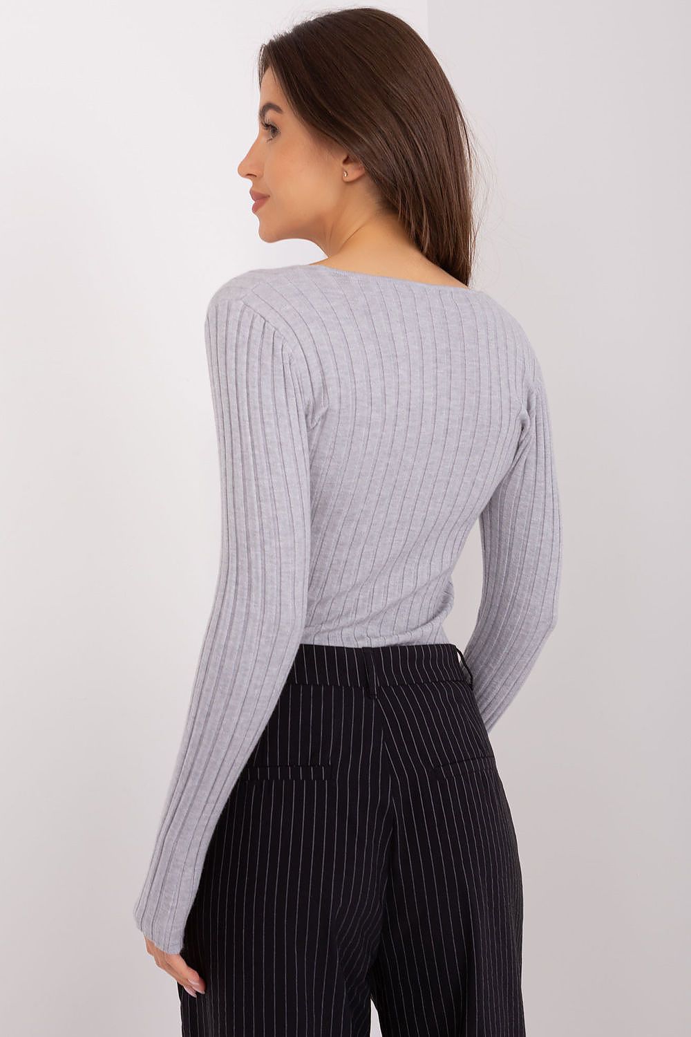 back of a  gray ribbed sweater with long sleeves 
