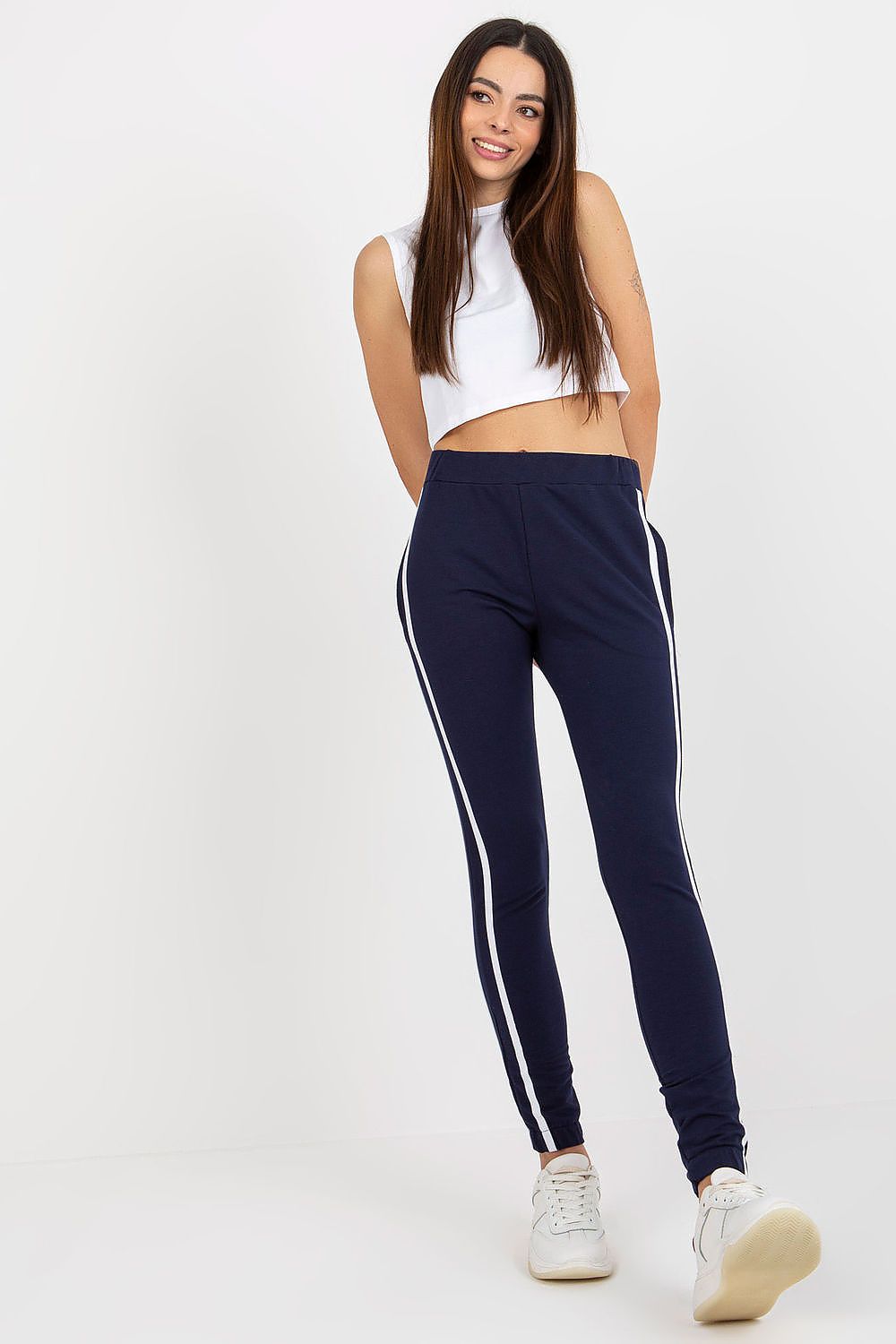 Woman wearing navy leggings with white stripes 