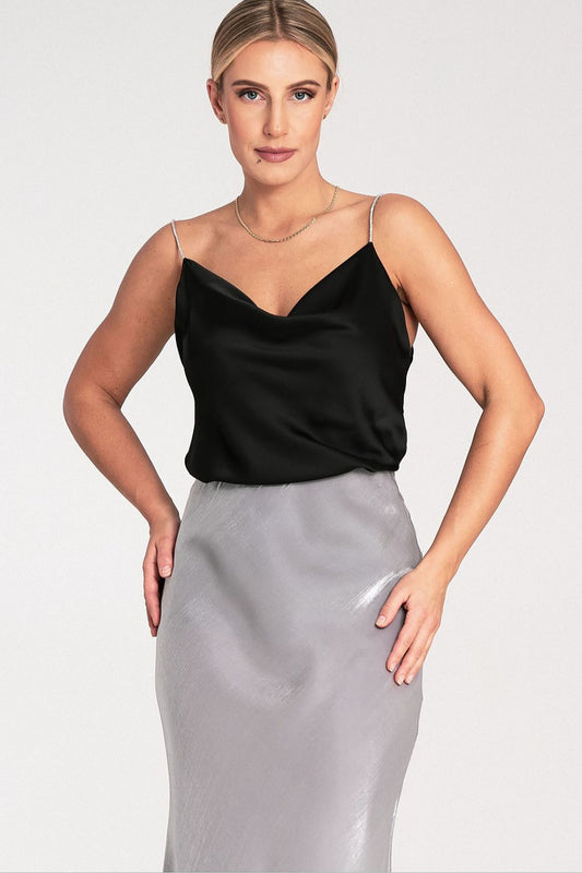Woman wearing a black top and gray skirt 
