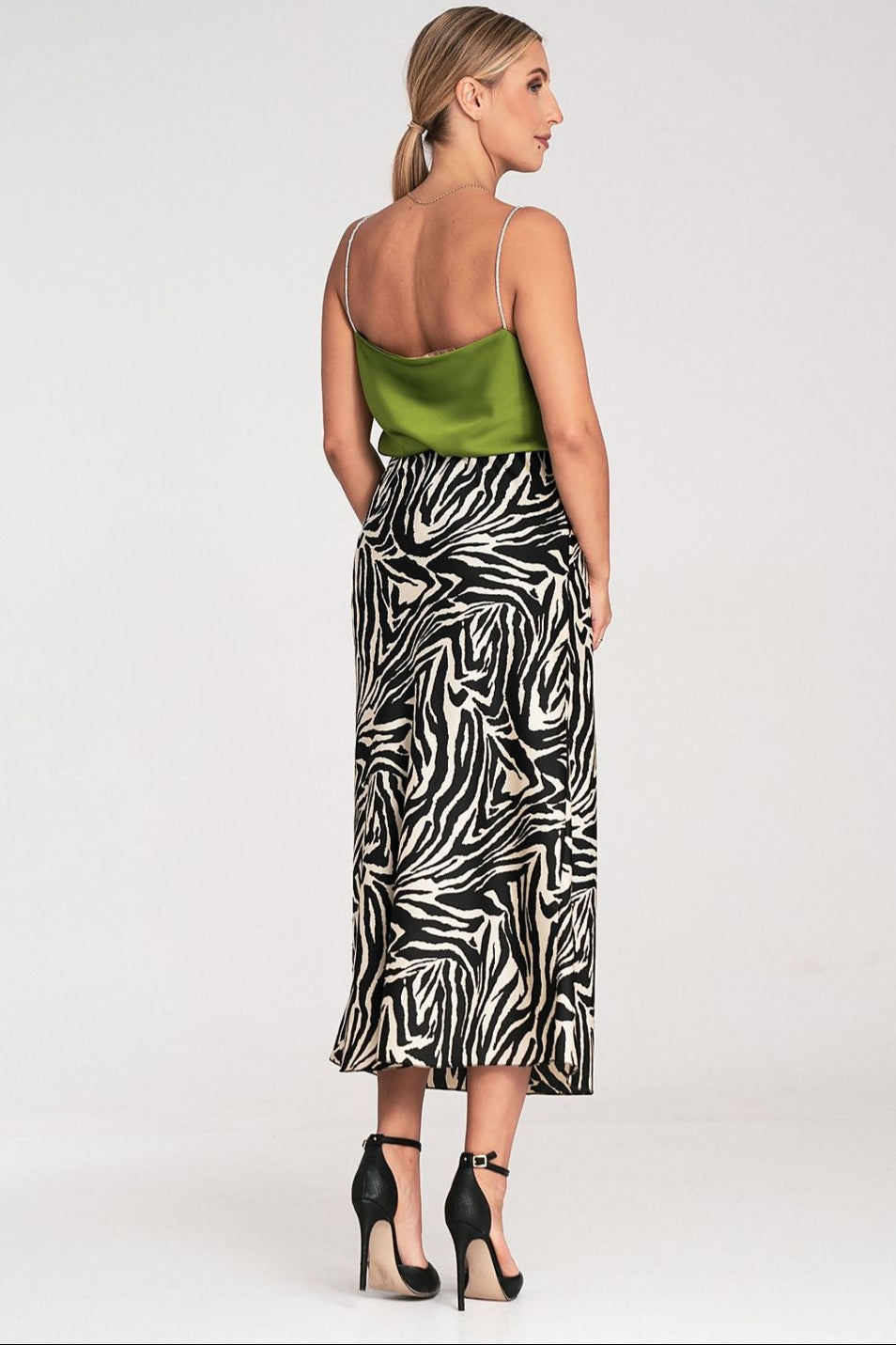  back look of a dressy green satin top and a zebra skirt 