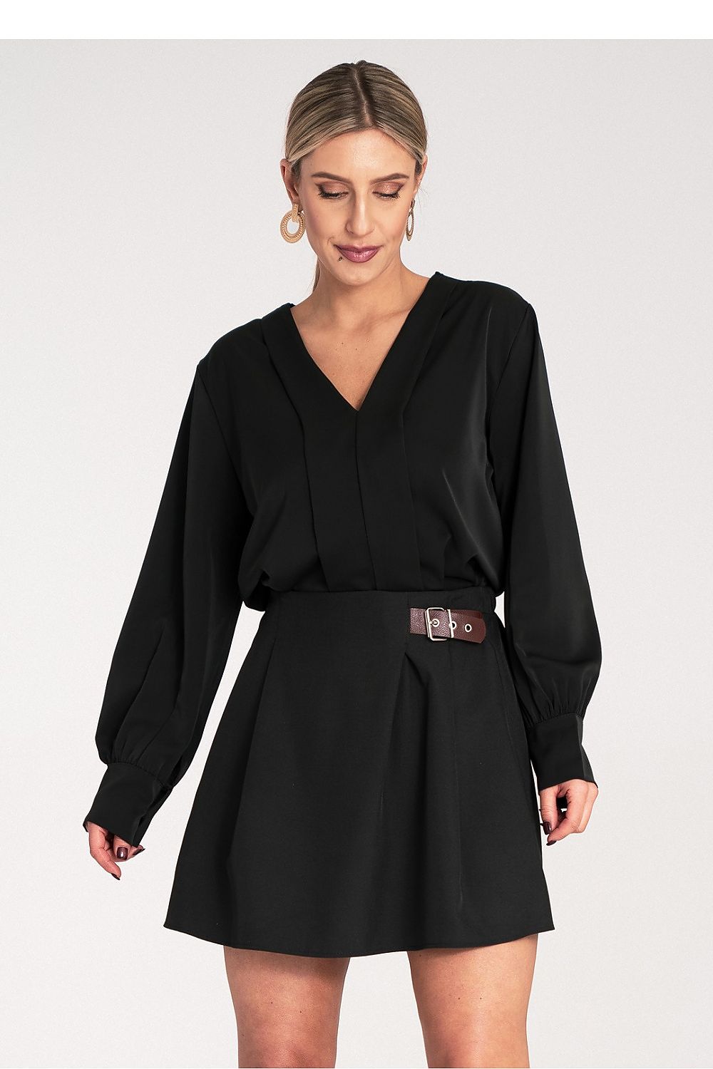 Woman wearing an european  black top and a black skirt 