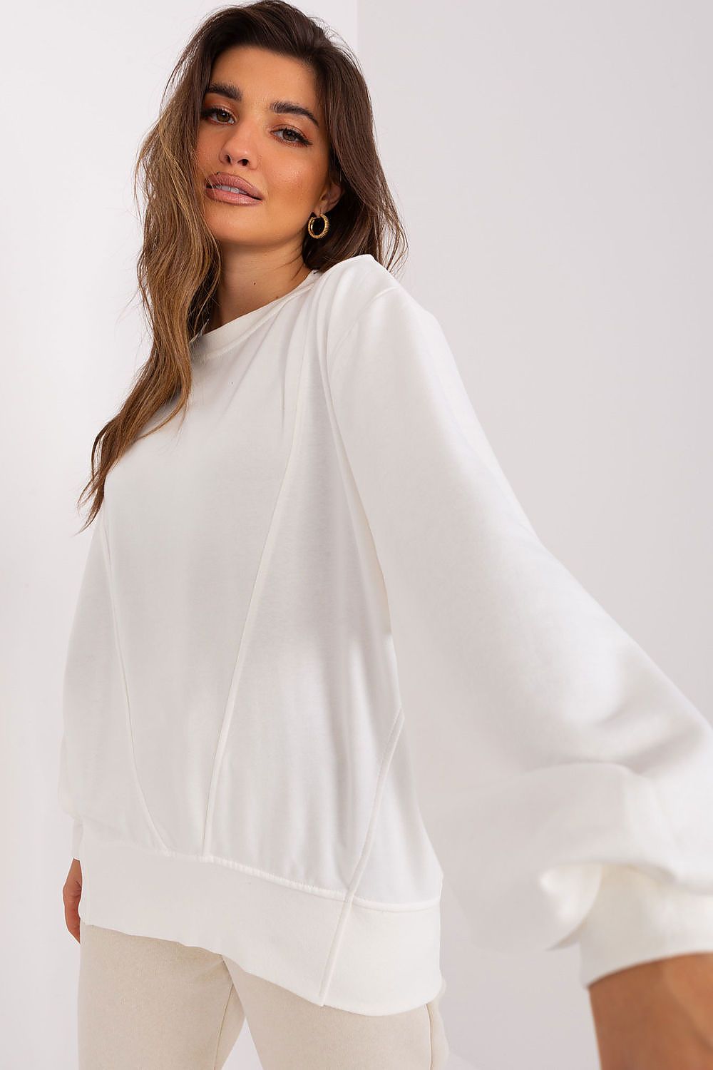 Woman wearing a white oversized sweater 