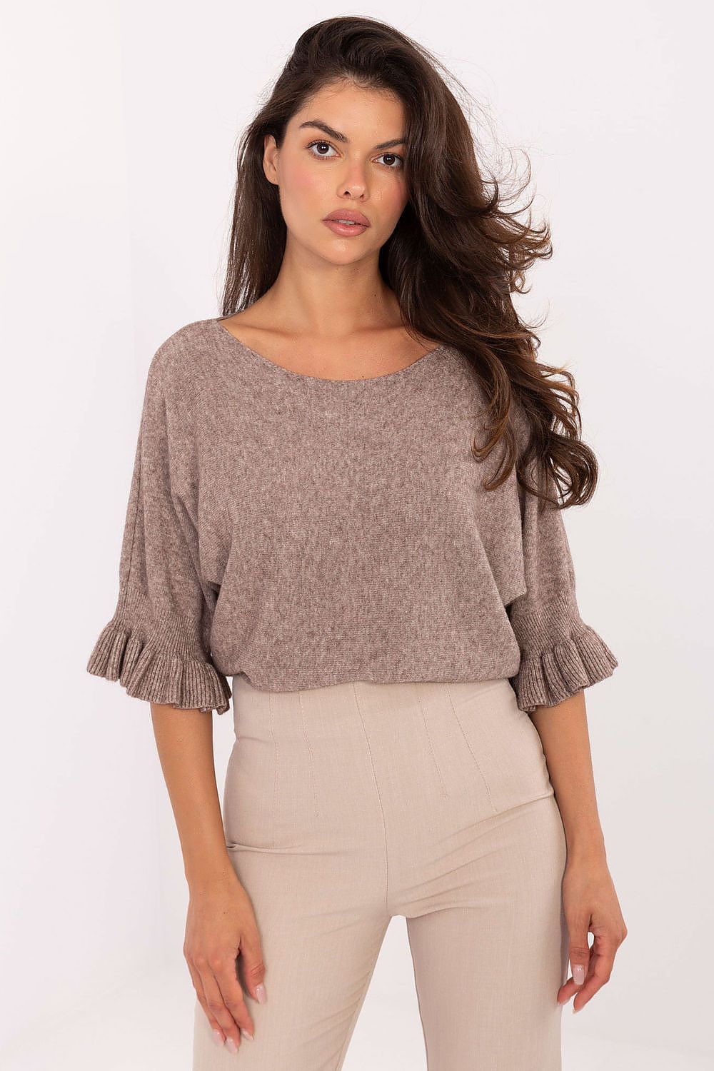 Woman wearing a brown sweater with on a white background