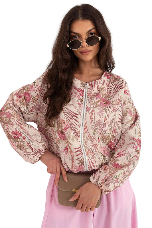 Front view of a model wearing a pink floral print long-sleeve button-up blouse with pink trousers