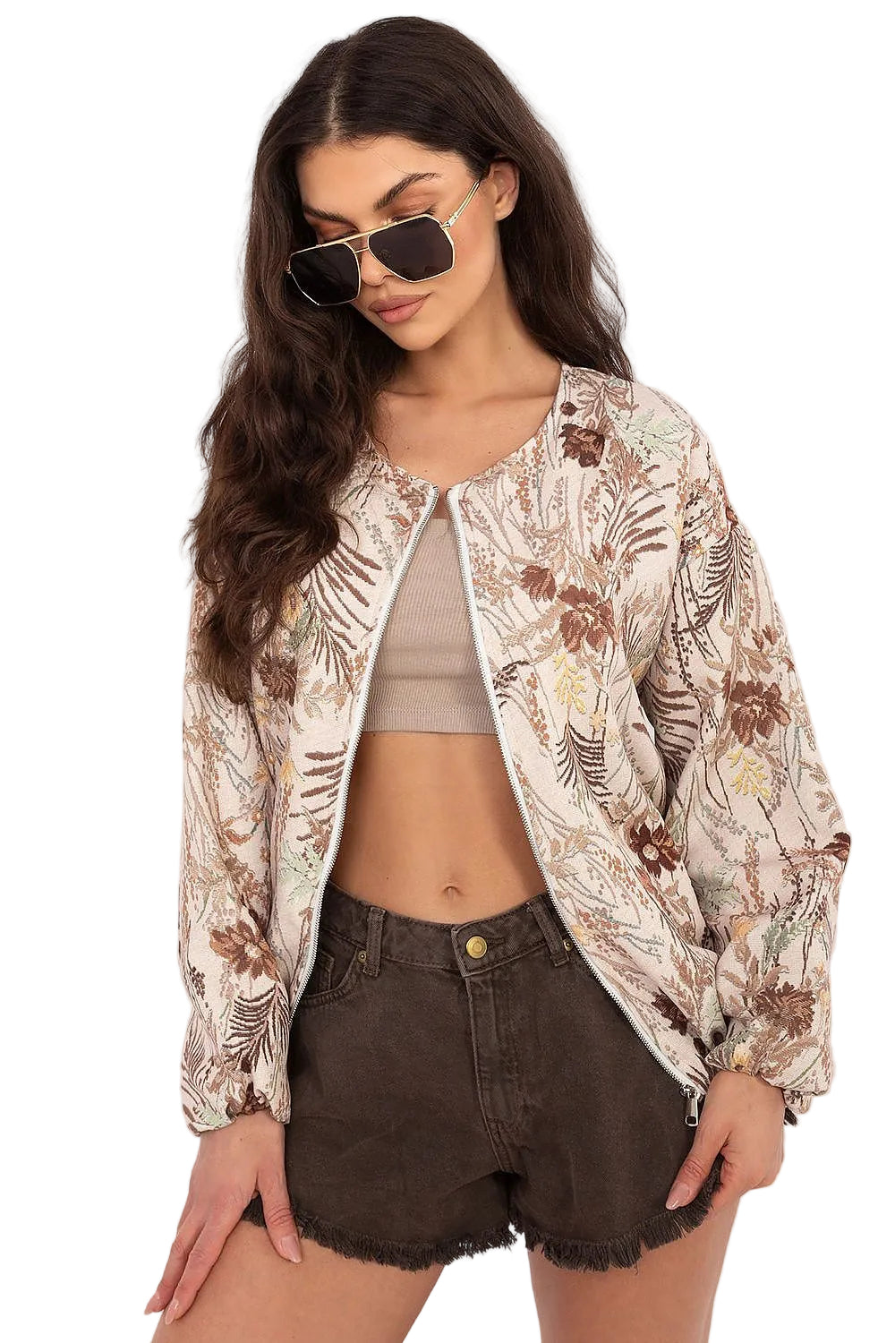 Front view of a model wearing a neutral cream floral print button-down shirt paired with dark shorts.