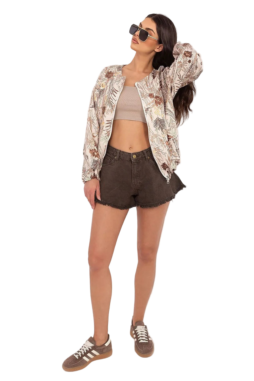 Full-body shot of a model wearing an open cream floral blouse over a dark top and shorts.
