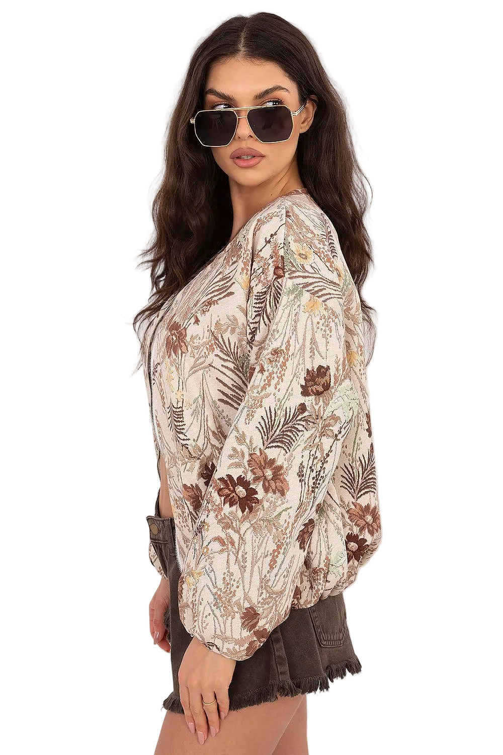 Side profile view of a model showcasing the collar and sleeve structure of a neutral floral blouse.