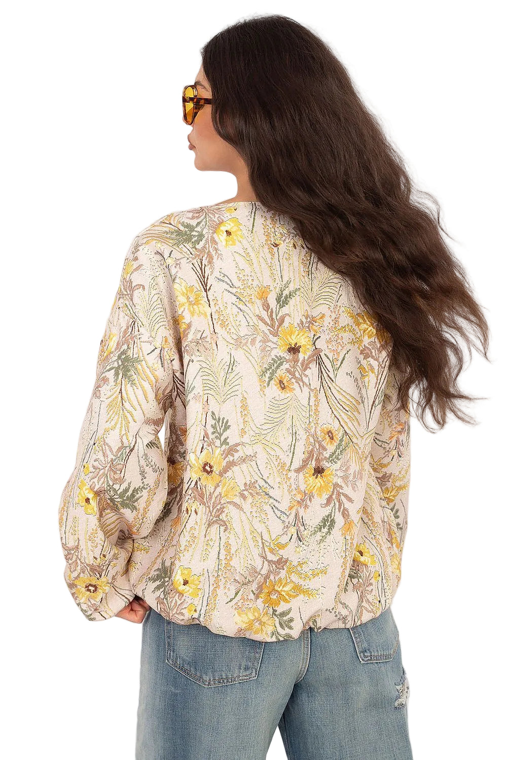 Back view of a model highlighting the relaxed shoulders of a cream and yellow floral print shirt.
