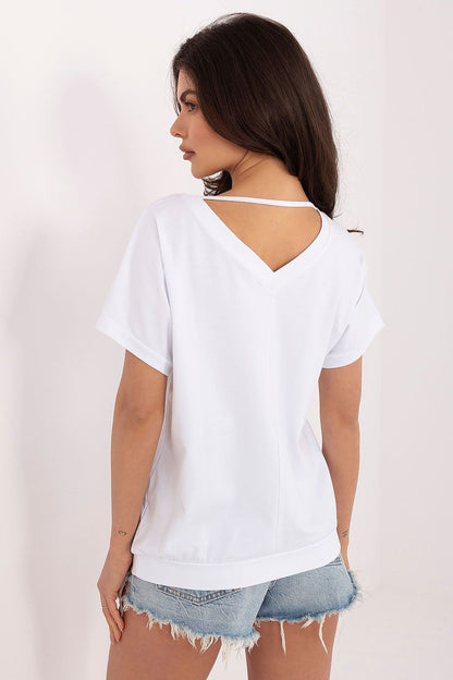 Back view of women's V-neck short sleeve blouse styled in white