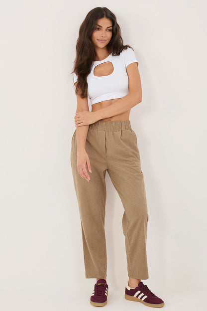 Model wearing relaxed fit ribbed corduroy trousers, elastic waist, front view
