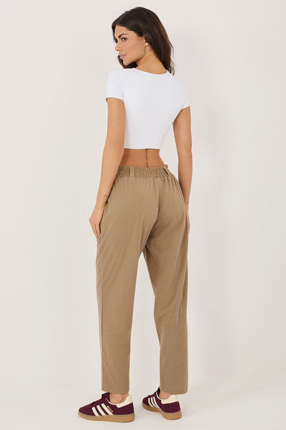 Full length back view of model in ribbed corduroy pull-on trousers
