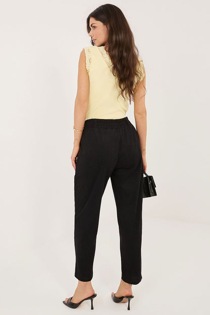Ribbed corduroy straight leg trousers on model, elastic waist, back view
