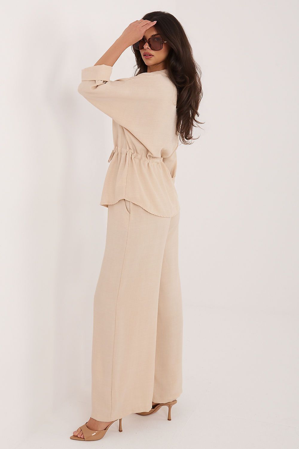 Model in wide leg elastic waist trousers with matching linen shirt, front view full length
