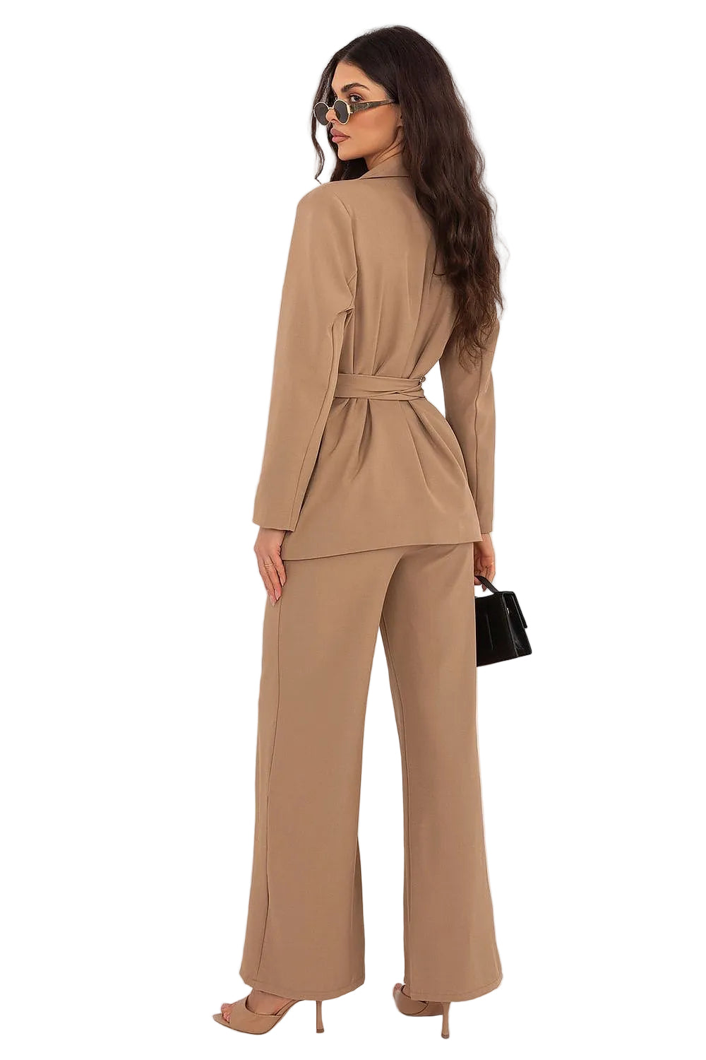 Close-up shot of a model posing in a brown tailored blazer set, highlighting the texture of the fabric and structured shoulder lines.