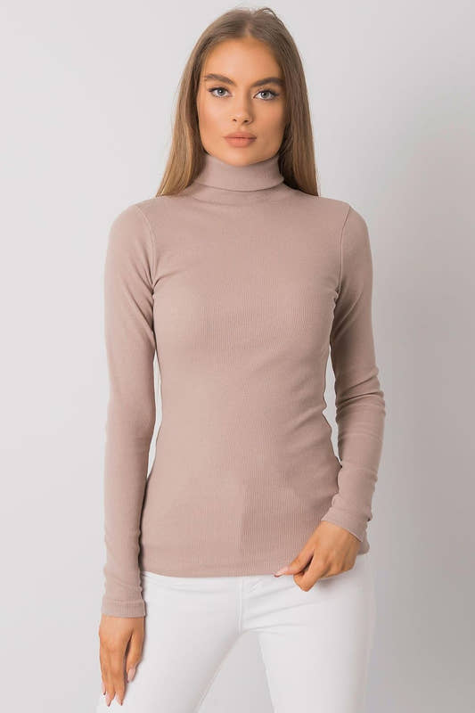 Woman wearing a beige turtleneck sweater 