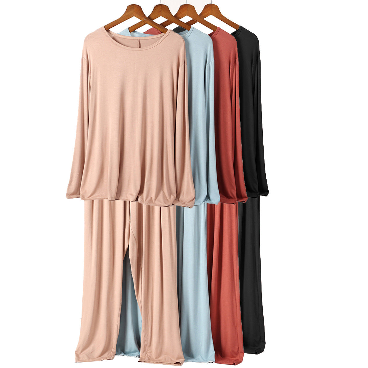 Four long-sleeve pajama sets in different colors on hangers
