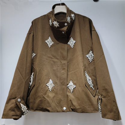 A brown suede jacket with silver rhinestone snowflake embellishments.