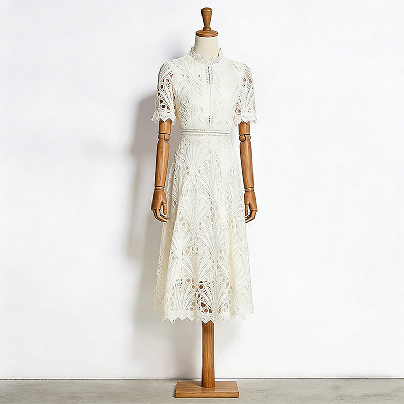 White lace dress on a wooden mannequin against a white background