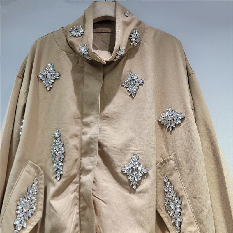 Beige jacket with silver embellishments on a plain background