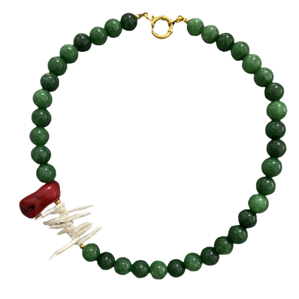 Green beaded necklace with a red and white pendant 