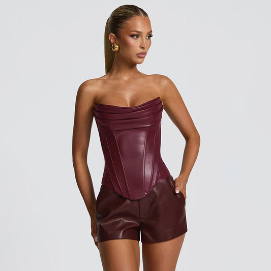 Woman wearing a strapless maroon leather outfit 