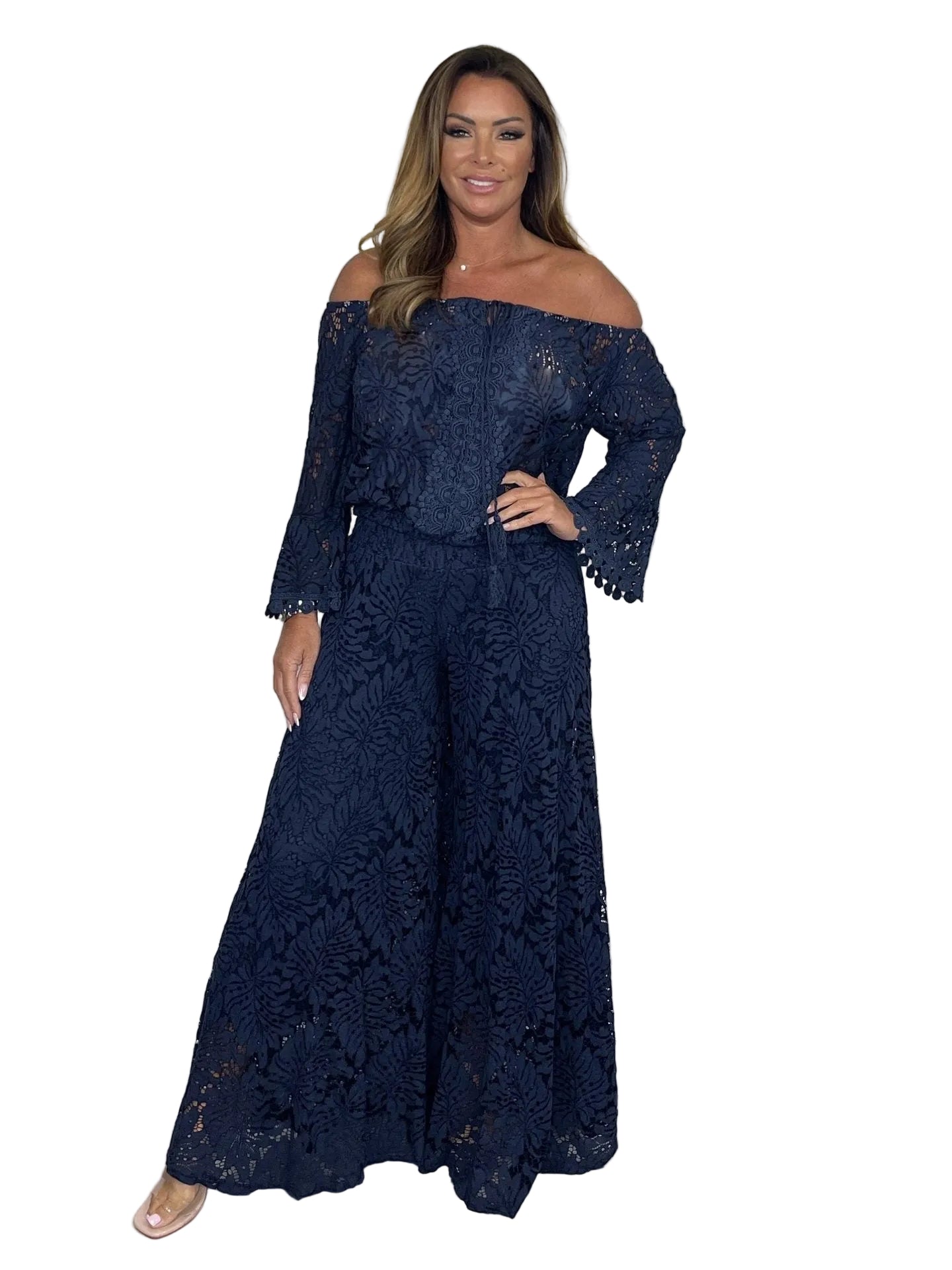Woman wearing a navy lace off-shoulder top and wide-leg pants 