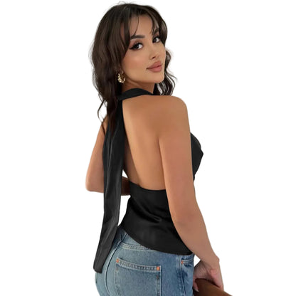 Woman wearing a black halter top and blue jeans 