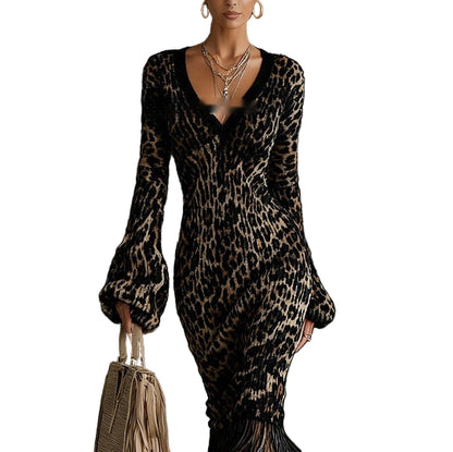 Woman wearing a leopard print dress holding a handbag