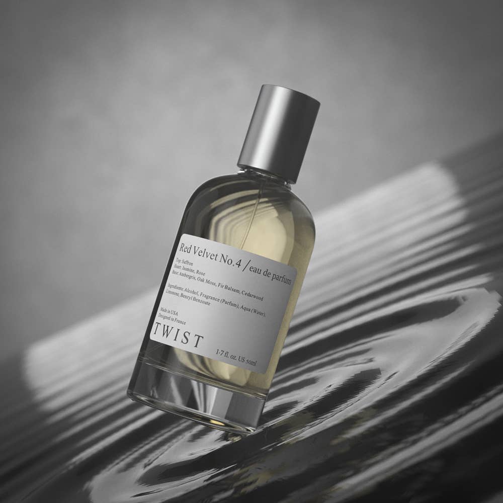 Perfume bottle labeled 'TWIST' on a reflective surface 