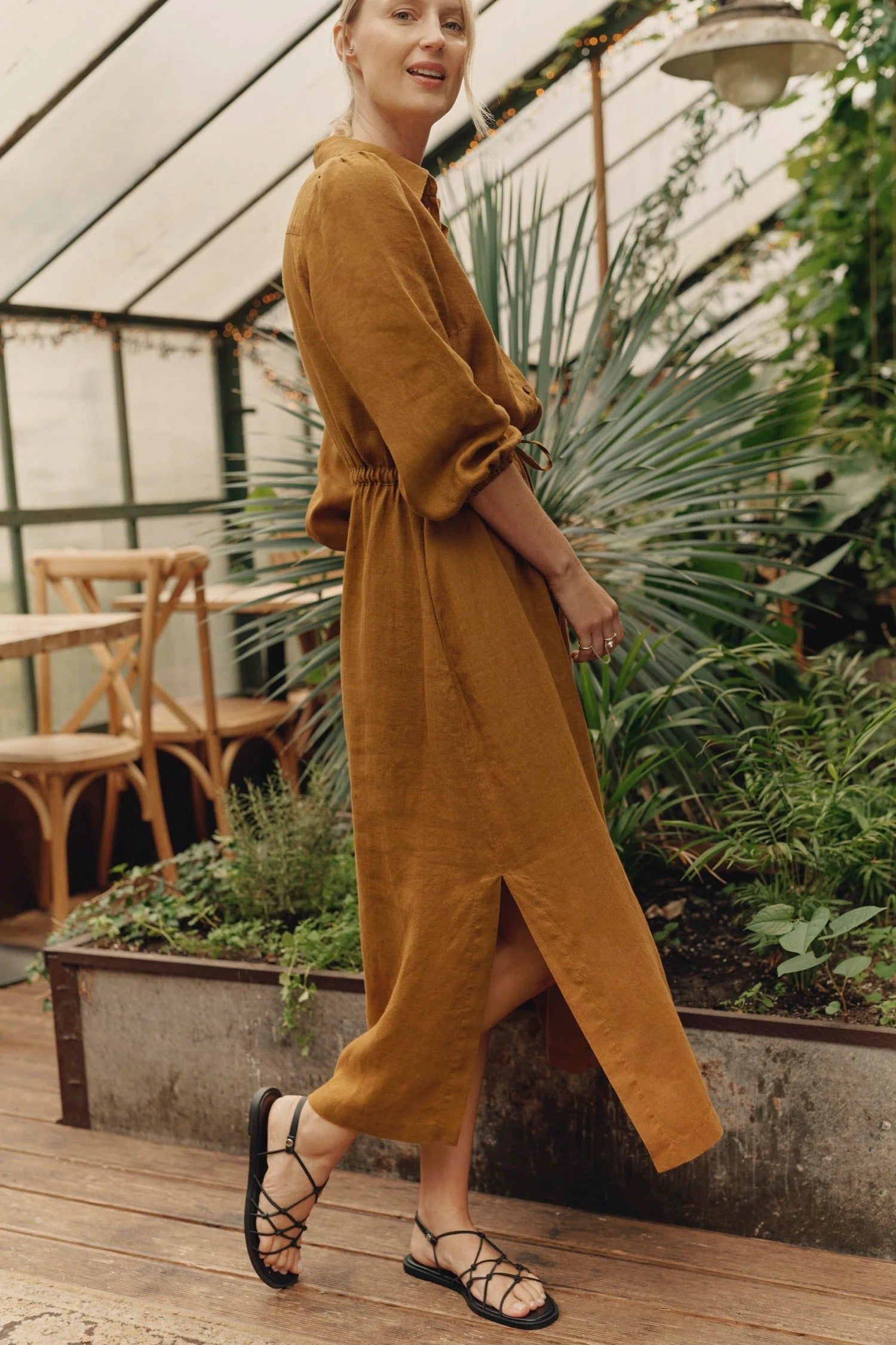 Woman wearing bronze linen shirt dress with button-down front and belt