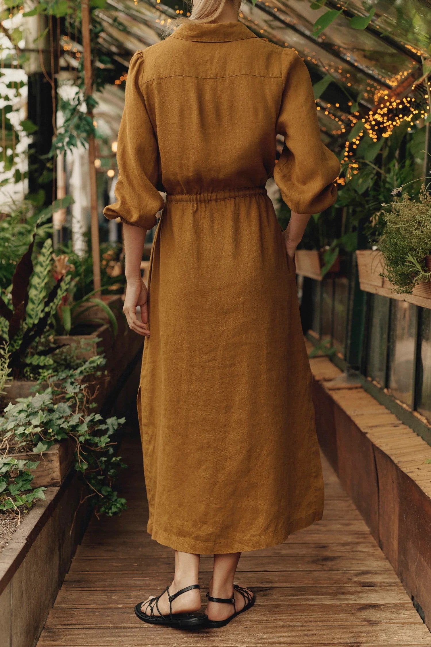 Back view of ethically made bronze linen dress with elastic cuffs