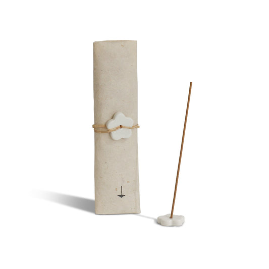 Incense stick with a white ceramic holder on a white background