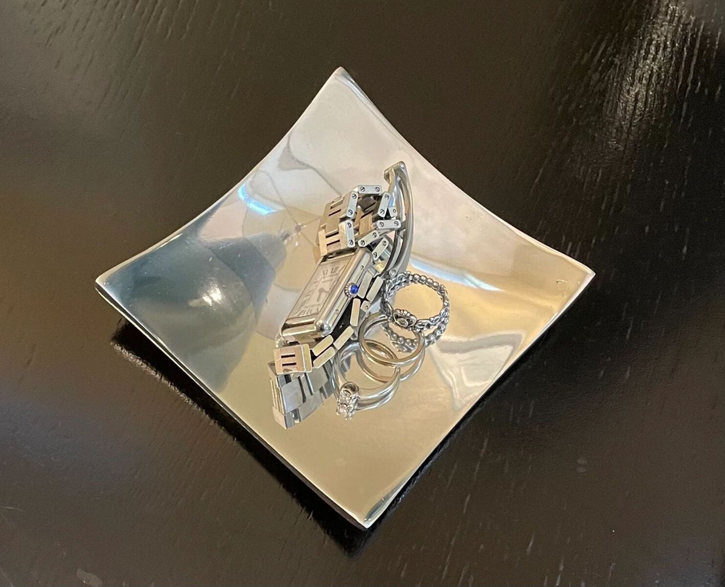 Set of rings on a reflective surface with a dark background